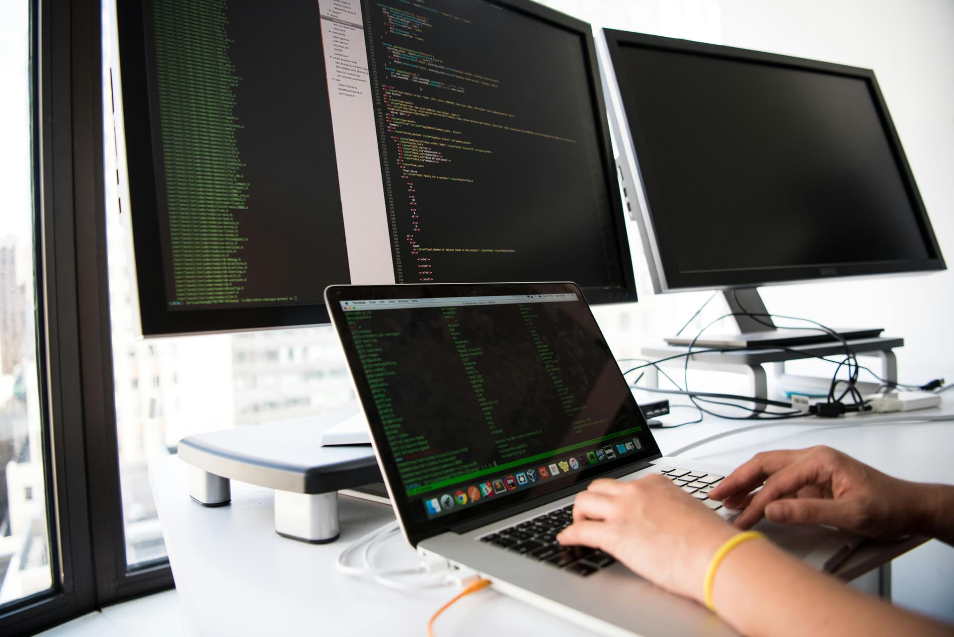 Developer working across multiple screens and codebases